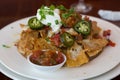 Baked nachos with sour cream, salsa,and pickled jalapenos