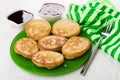 Oat pancakes in plate, napkin, blueberry jam, strawberry jam, fork Royalty Free Stock Photo