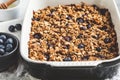 Baked oatmeal with blueberries and honey in oven dish. Oatmeal fruit crumble pie