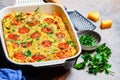 Baked omelet frittata with tomatoes and cheese in oven dish, Top View. Baked omelet with vegetables and cheese Royalty Free Stock Photo