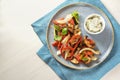 Baked oven vegetables such as bell pepper, tomato, zucchini, mushroom, fennel and eggplant with parsley garnish and a cream cheese