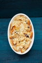 Baked panettone pudding in oval baking dish on navy blue background