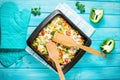 Baked pasta with broccoli and cheesy tomato sauce on blue wood background Royalty Free Stock Photo