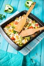 Baked pasta with broccoli and cheesy tomato sauce on blue wood background Royalty Free Stock Photo