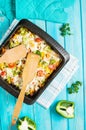 Baked pasta with broccoli and cheesy tomato sauce on blue wood background Royalty Free Stock Photo