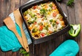 Baked pasta with broccoli and cheesy tomato sauce on wood background Royalty Free Stock Photo