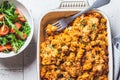 Baked pasta with chicken and cheese in oven dish, top view, gray background. Italian cuisine concept Royalty Free Stock Photo