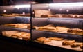 Baked pastry under glass window in the bakery. Bread, pastry display window