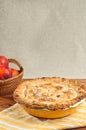 Baked peach pie and basket of whole peaches