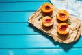 Baked peaches with honey and cinnamon on blue wooden background. summer dessert. Top view and copy space.