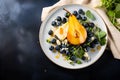 Baked Pear and blue cheese salad served on white plate with blueberries, mIcrogreens and honey topping on dark background with Royalty Free Stock Photo