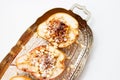 Baked pears with nuts and honey syrupon a silver tray