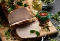 Baked piece of pork balyk on the table with spices. Tenderloin cut into pieces