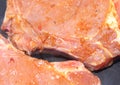 Baked piece of pork meat on aluminum foil, the process of cooking meat dishes in the oven.