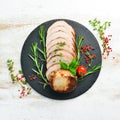 Baked piece of pork with rosemary. Top view.