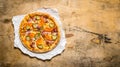 Baked pizza with bacon and tomatoes. On wooden table. Royalty Free Stock Photo