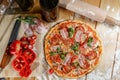 Baked pizza with ham and paprika and ingredients. Italian traditional food Royalty Free Stock Photo