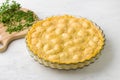 Baked polenta in a baking dish and parsley on a light gray background. Delicious Italian food