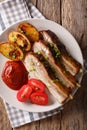 Baked pork brisket with potatoes and sauce close up. vertical to Royalty Free Stock Photo