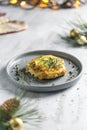Baked pork with cheese and thyme in a gray plate on a gray background in the new year`s serving