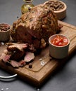 Baked pork collar with spices on a wooden board, delicious and juicy meat