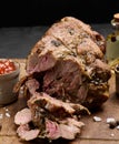 Baked pork collar with spices on a wooden board, delicious and juicy meat