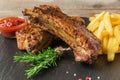 Baked pork ribs with french fries and red sauce Royalty Free Stock Photo