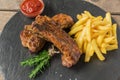 Baked pork ribs with french fries and red sauce Royalty Free Stock Photo