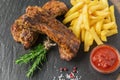 Baked pork ribs with french fries and red sauce Royalty Free Stock Photo