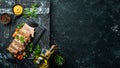 Baked pork ribs with mustard and spices on a black stone plate. Top view. Royalty Free Stock Photo