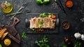 Baked pork ribs with mustard and spices on a black stone plate. Top view. Royalty Free Stock Photo