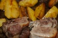 Photo of baked pork ribs and potatoes in oil and paprika close-up Royalty Free Stock Photo