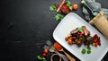 Baked pork ribs with vegetables. In the plate. Royalty Free Stock Photo