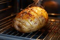 Baked potato being cooked in its jacket in a kitchen oven