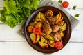 Baked potato with pieces roast goose, vegetables and corn grill. Royalty Free Stock Photo