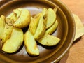 Baked potato chips dipped in tomato sauce