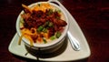 Baked Potato Soup On Fancy White Plate Served On Wood Table