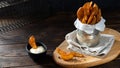 Baked potato wedges with addition sea salt and pepper on a black background, side view, close up, copy space Royalty Free Stock Photo