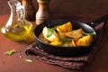 Baked potato wedges in black frying pan Royalty Free Stock Photo