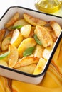 Baked potato wedges in enamel baking dish Royalty Free Stock Photo