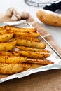 Baked potato wedges on tray - homemade organic vegetable, vegan potato wedges snack