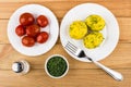 Baked potatoes with dill, bowl with greens, salt, pickled tomato