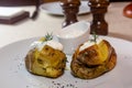 Baked potatoes with dill and sour cream on a plate