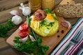 Baked potatoes with fried egg, chives, cheese and bacon Royalty Free Stock Photo