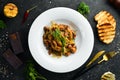 Baked potatoes with meat, mushrooms, onions and garlic on a plate. Royalty Free Stock Photo