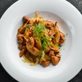 Baked potatoes with meat, mushrooms, onions and garlic on a plate. Royalty Free Stock Photo