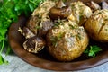 Baked potatoes with mushrooms, cheese and herbs on dark wooden background. Royalty Free Stock Photo