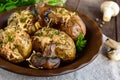Baked potatoes with mushrooms, cheese and herbs on dark wooden background. Royalty Free Stock Photo