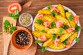 Baked potatoes in a peel with tomatoes, herbs, spices and sesame Royalty Free Stock Photo