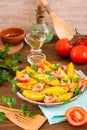 Baked potatoes in a peel with tomatoes in a plate Royalty Free Stock Photo